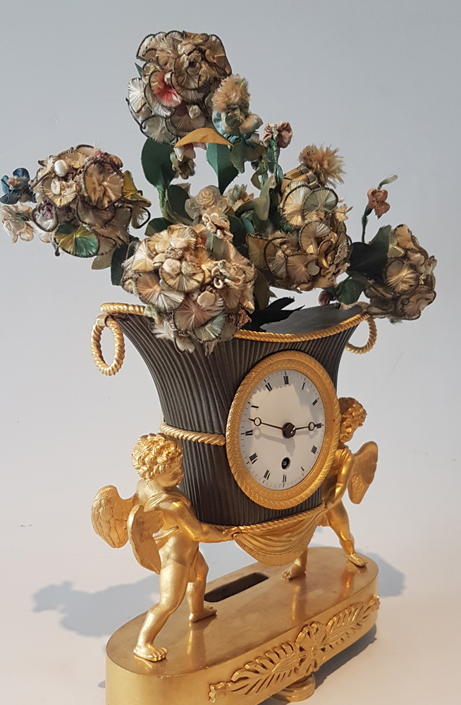 French Empire Ormolu and Patinated Bronze Clock of Amorettis holding up Basket Flowers
