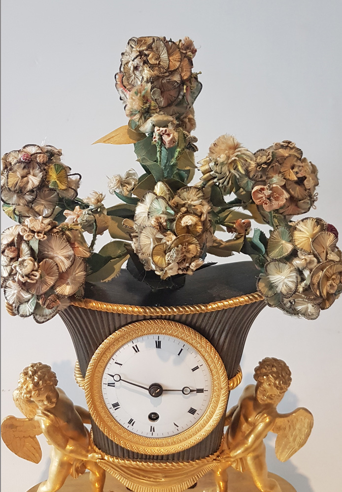 French Empire Ormolu and Patinated Bronze Clock of Amorettis holding up Basket Flowers