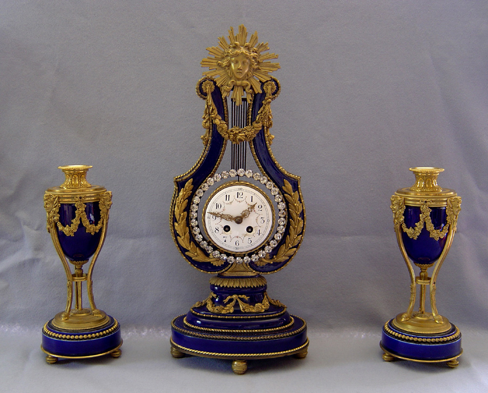 Antique French Blue du Roi porcelain & ormolu lyre clock with matching cassolettes.