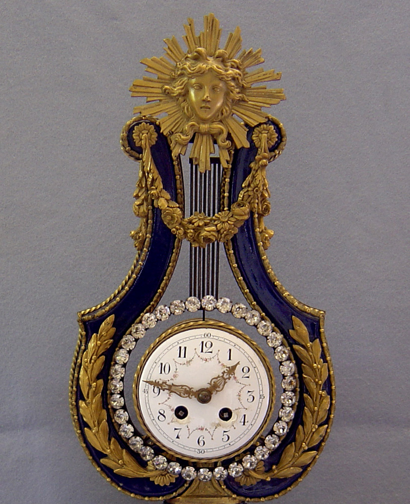 Antique French Blue du Roi porcelain & ormolu lyre clock with matching cassolettes.