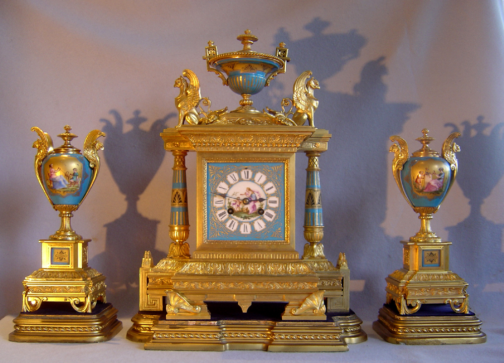 French antique clock set in ormolu and bleu celeste porcelain on original stands.