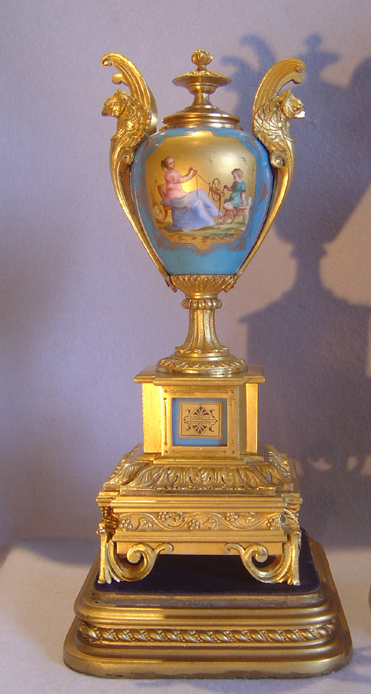 French antique clock set in ormolu and bleu celeste porcelain on original stands.