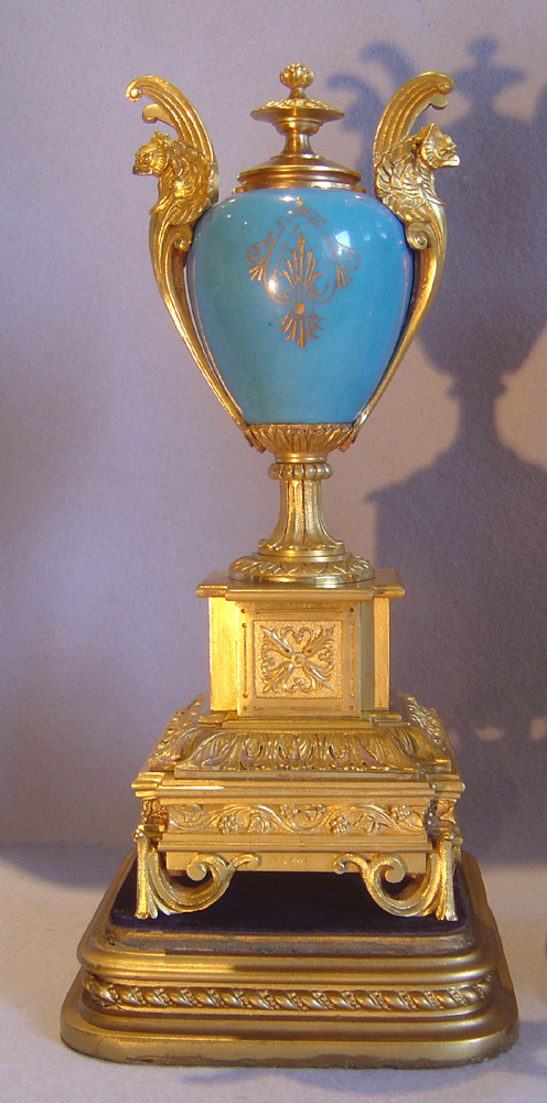 French antique clock set in ormolu and bleu celeste porcelain on original stands.
