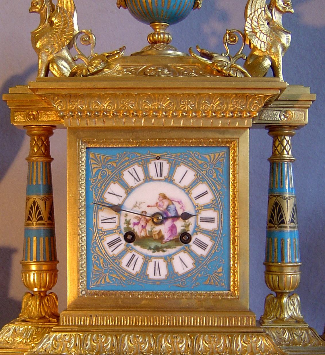 French antique clock set in ormolu and bleu celeste porcelain on original stands.