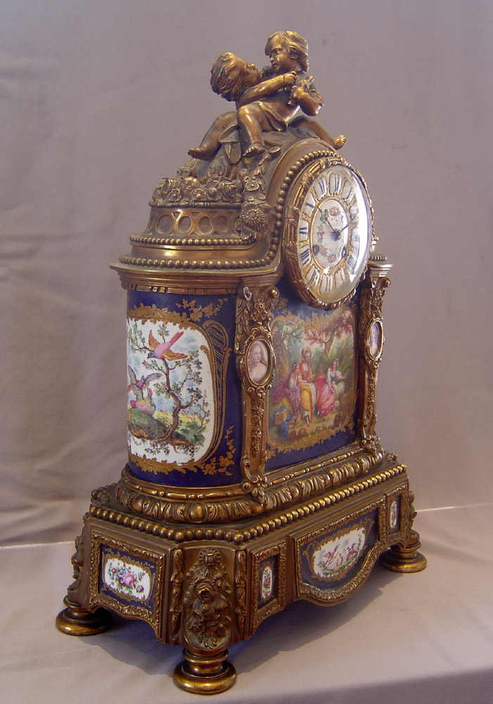 Antique French porcelain and ormolu mantle clock with painting after Boucher.