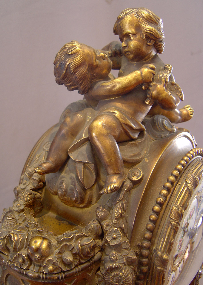Antique French porcelain and ormolu mantle clock with painting after Boucher.