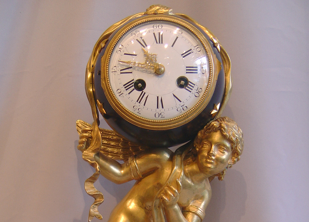 French antique Napoleon III mantel clock of Cupid carrying time.