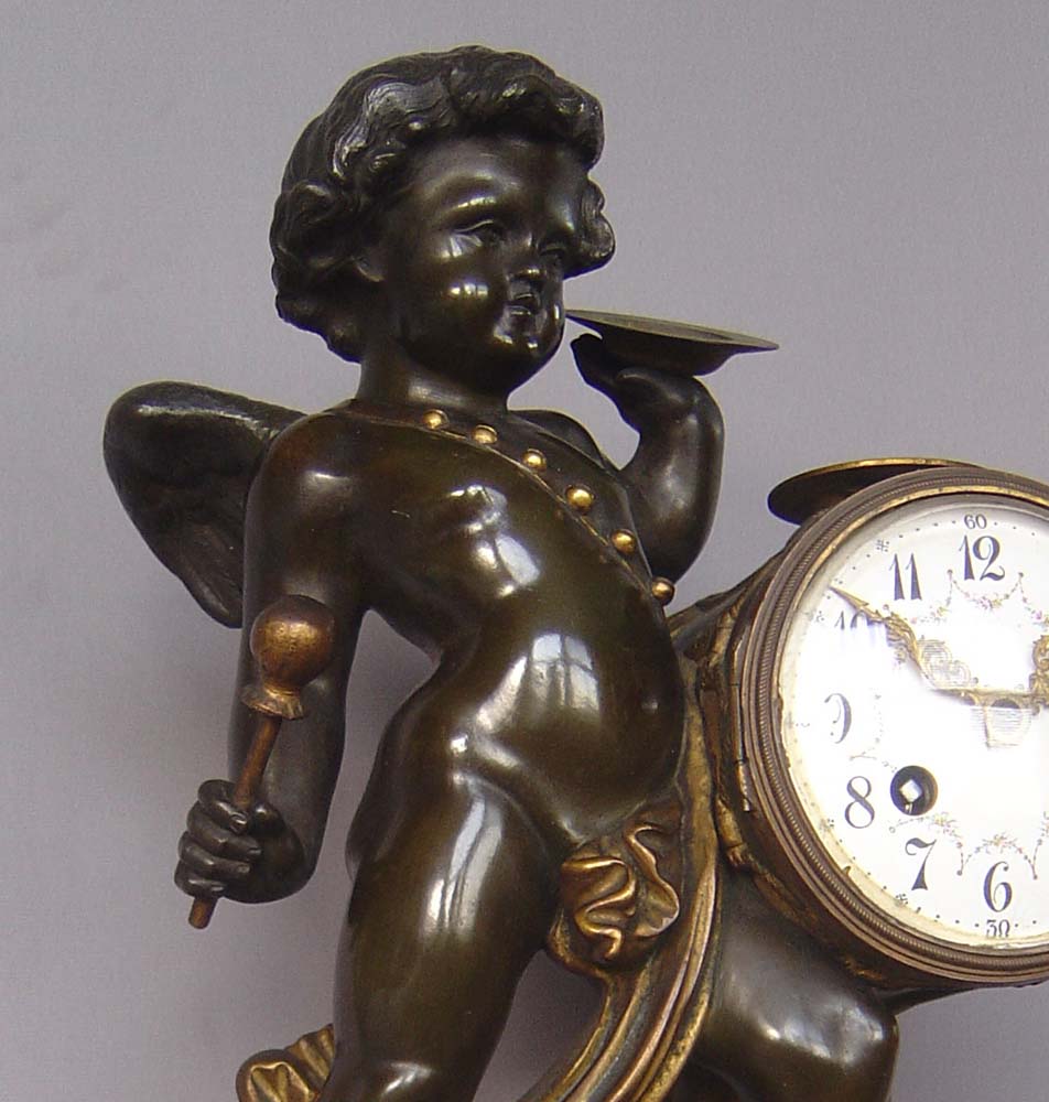 Antique clock French patinated and gilt bronze with griotte marble of Cupid playing drum and cymbal.