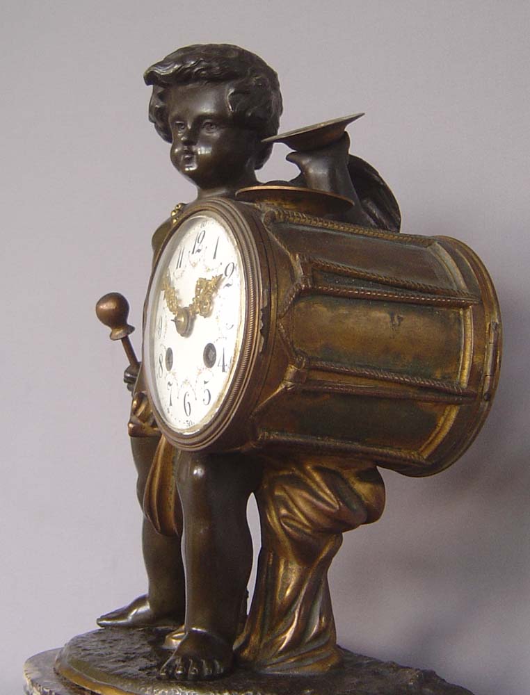 Antique clock French patinated and gilt bronze with griotte marble of Cupid playing drum and cymbal.