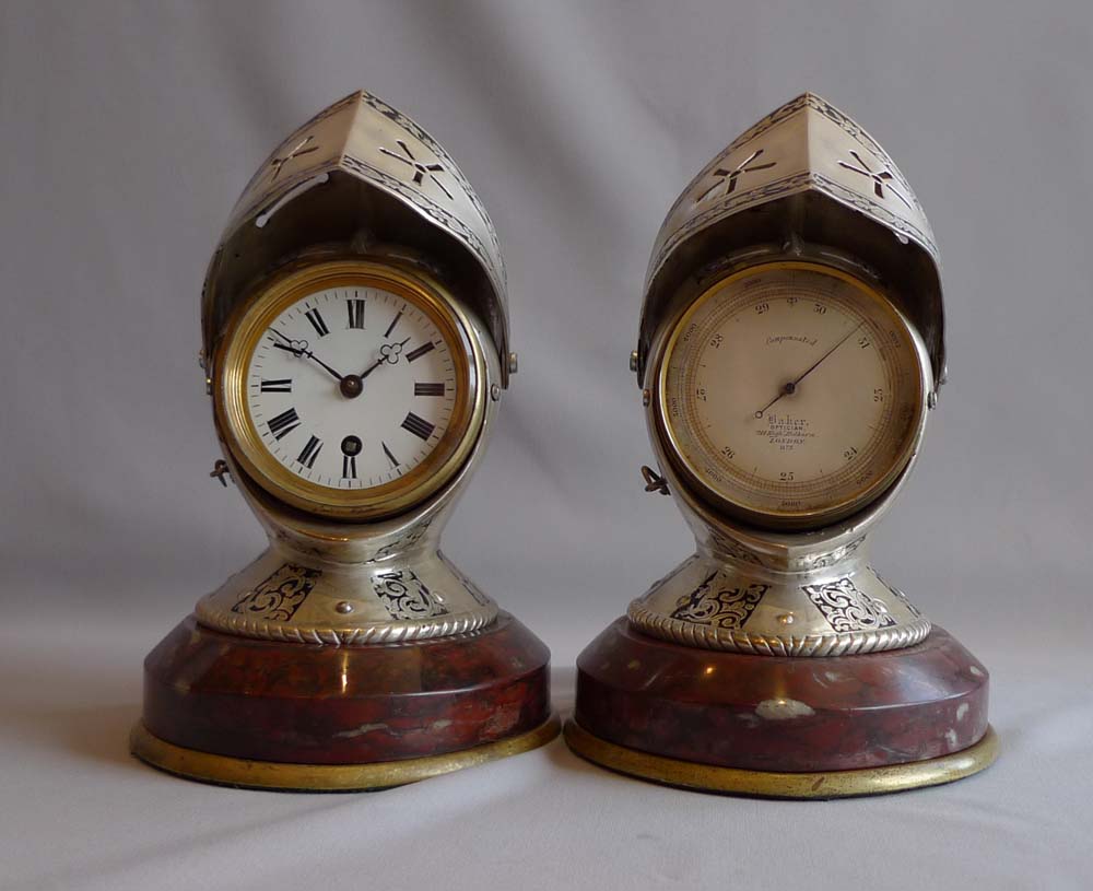 Antique desk clock and barometer in form of silvered and engraved medieval helmets with visors.