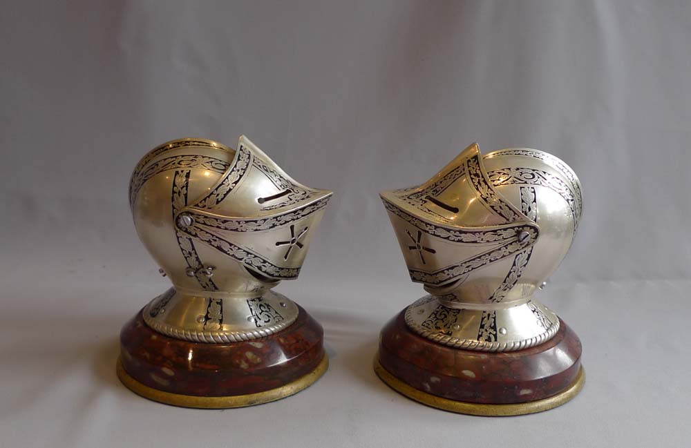 Antique desk clock and barometer in form of silvered and engraved medieval helmets with visors.