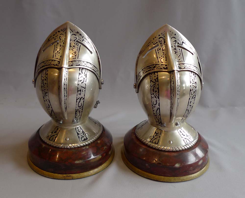 Antique desk clock and barometer in form of silvered and engraved medieval helmets with visors.