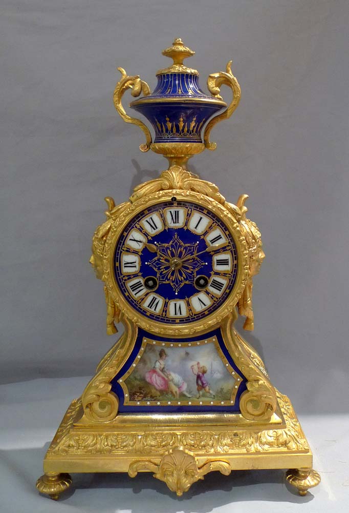 Antique French ormolu and blue jewelled porcelain mantel clock.