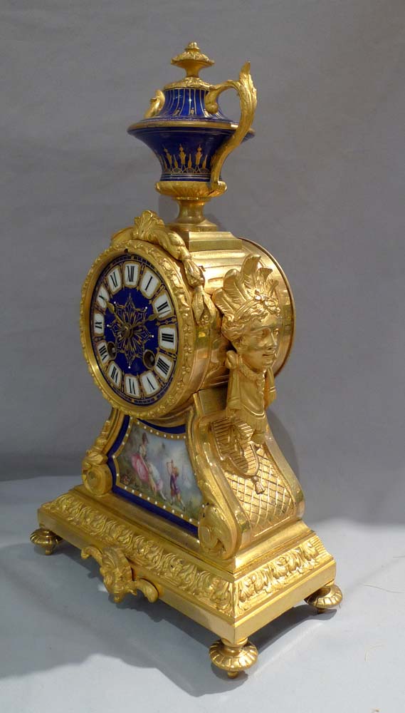 Antique French ormolu and blue jewelled porcelain mantel clock.