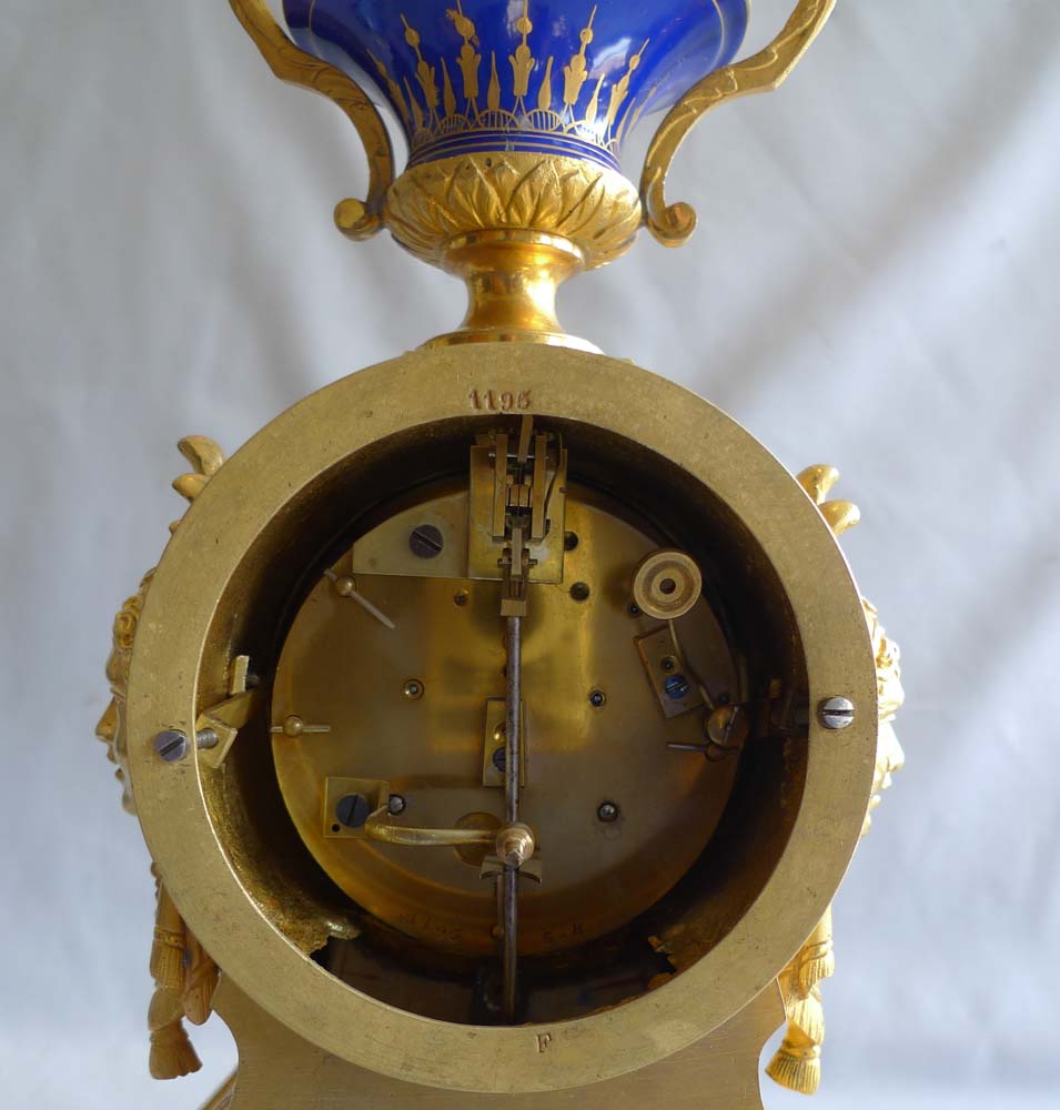 Antique French ormolu and blue jewelled porcelain mantel clock.