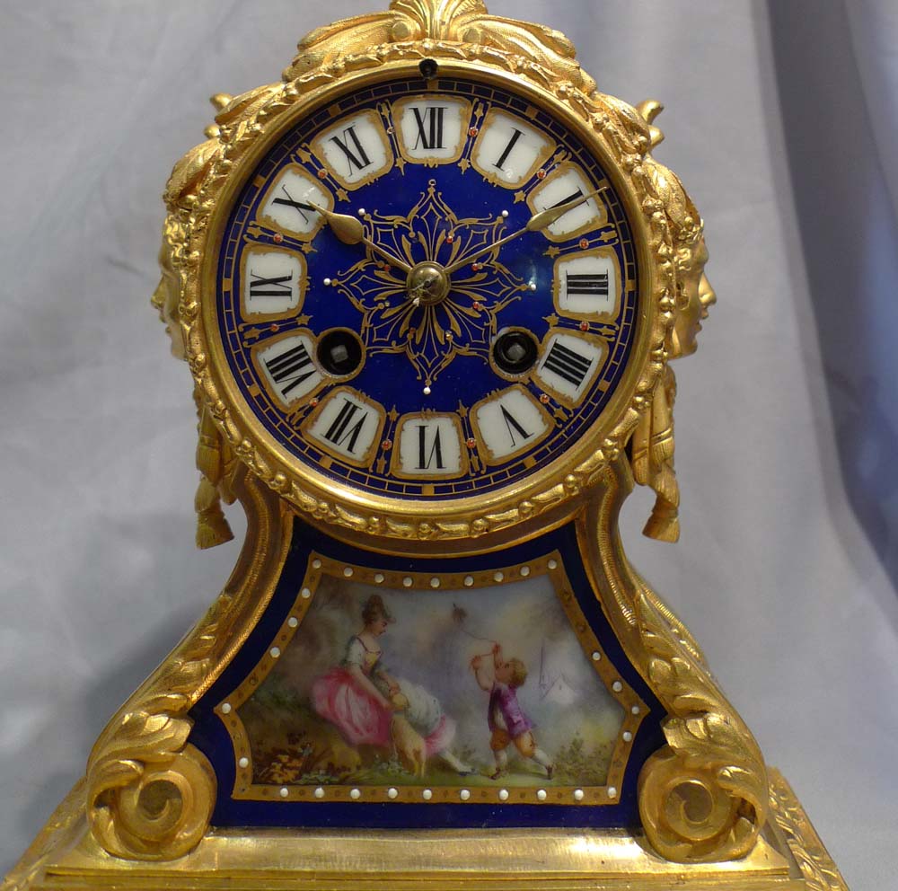 Antique French ormolu and blue jewelled porcelain mantel clock.