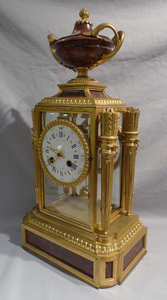 Antique French rouge marble and ormolu four glass clock signed
