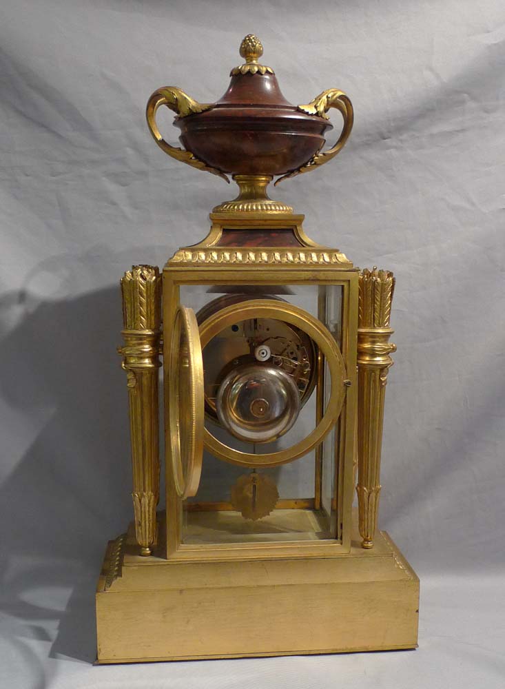Antique French rouge marble and ormolu four glass clock signed