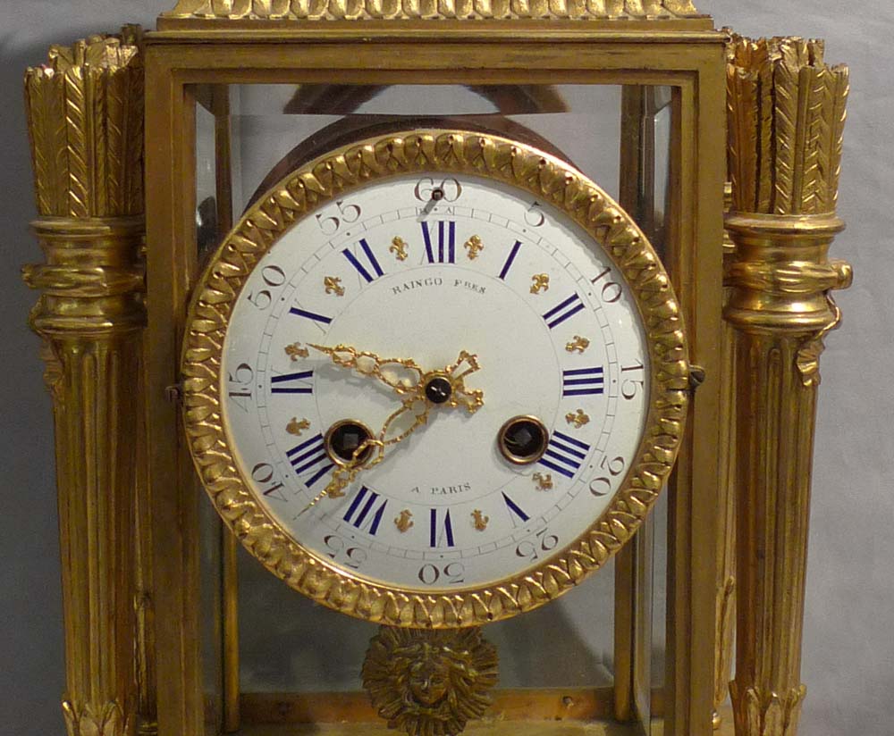 Antique French rouge marble and ormolu four glass clock signed