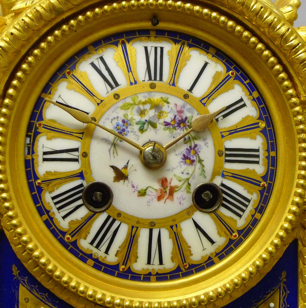Antique French mantel clock in porcelain and ormolu.