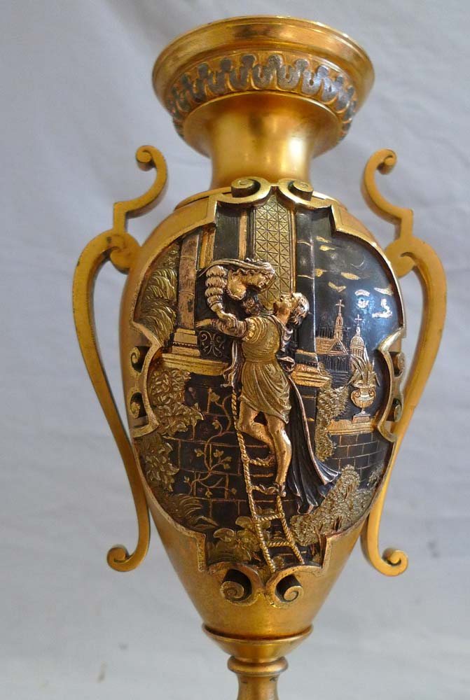 Antique French gilt and silvered bronze clock set with unusual panels.