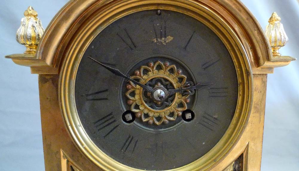 Antique French gilt and silvered bronze clock set with unusual panels.