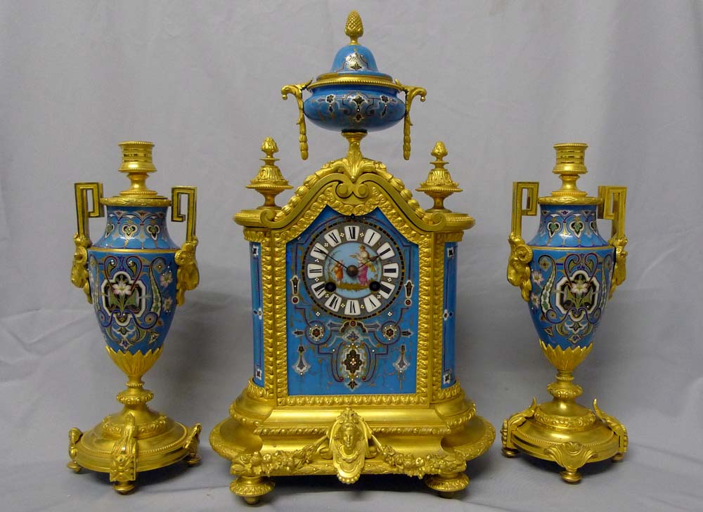 Antique porcelain and ormolu mantel clock set in blue with geometric moorish patterns.