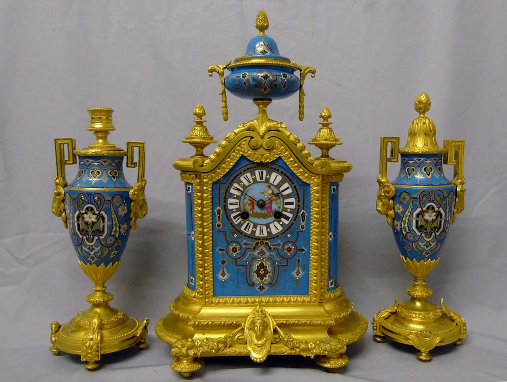 Antique porcelain and ormolu mantel clock set in blue with geometric moorish patterns.
