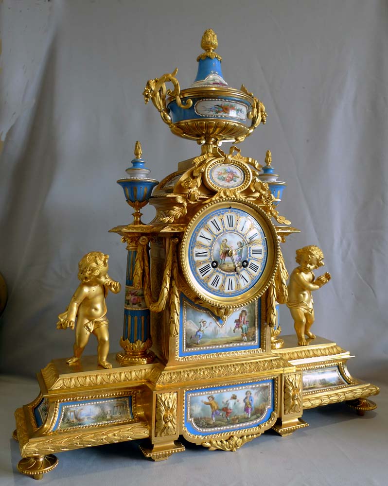 Big antique French ormolu and jewelled porcelain clock with hand painted panels of children playing.
