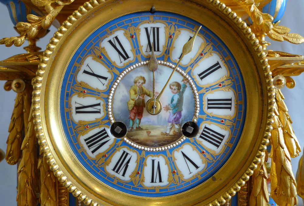 Big antique French ormolu and jewelled porcelain clock with hand painted panels of children playing.