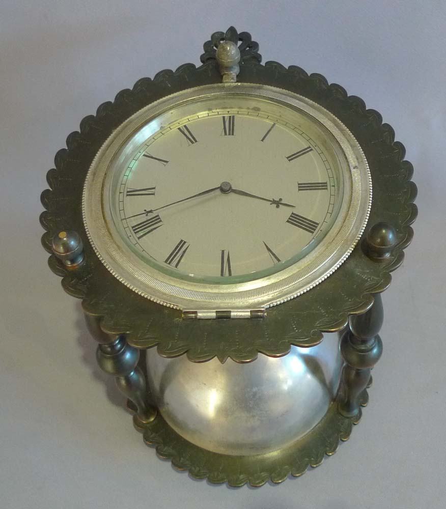 Antique and rare desk clock in the form of an hour glass in patinated and silvered bronze.