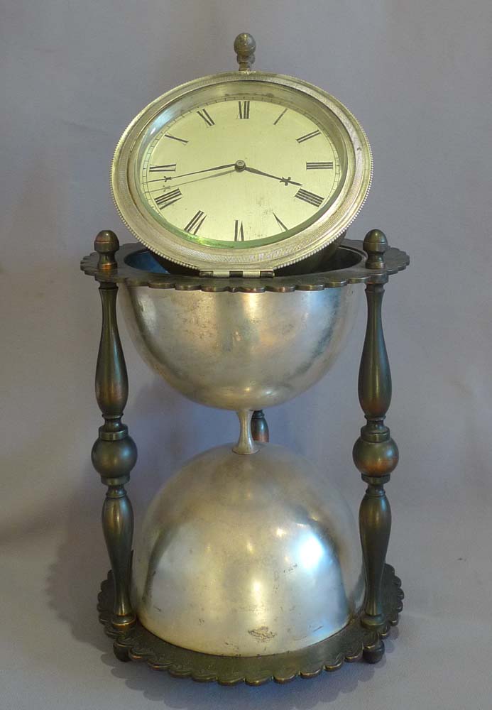 Antique and rare desk clock in the form of an hour glass in patinated and silvered bronze.