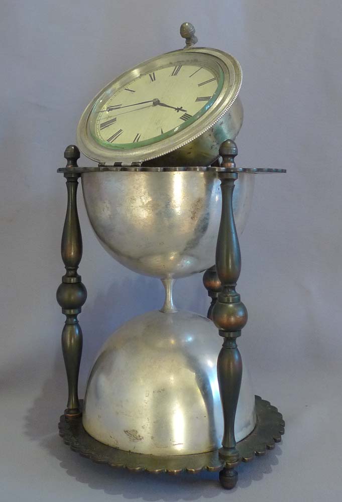 Antique and rare desk clock in the form of an hour glass in patinated and silvered bronze.