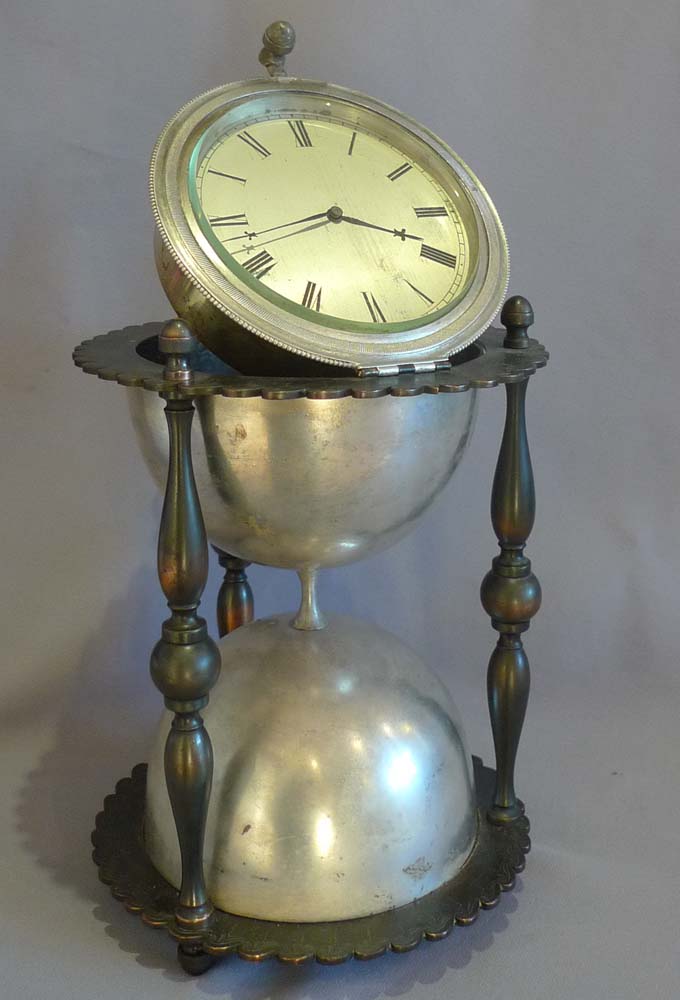 Antique and rare desk clock in the form of an hour glass in patinated and silvered bronze.