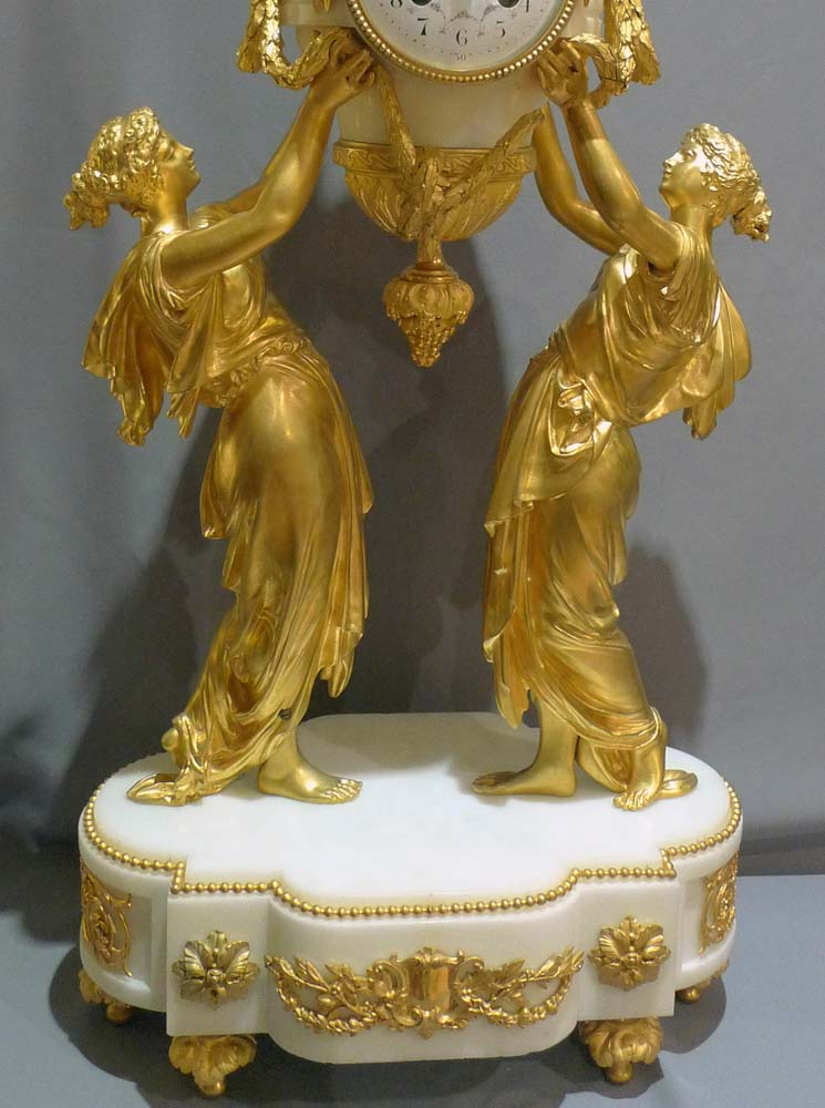 Antique French mantel clock of two women holding  up time.