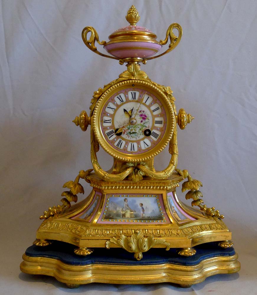 Antique French porcelain and ormolu clock set.