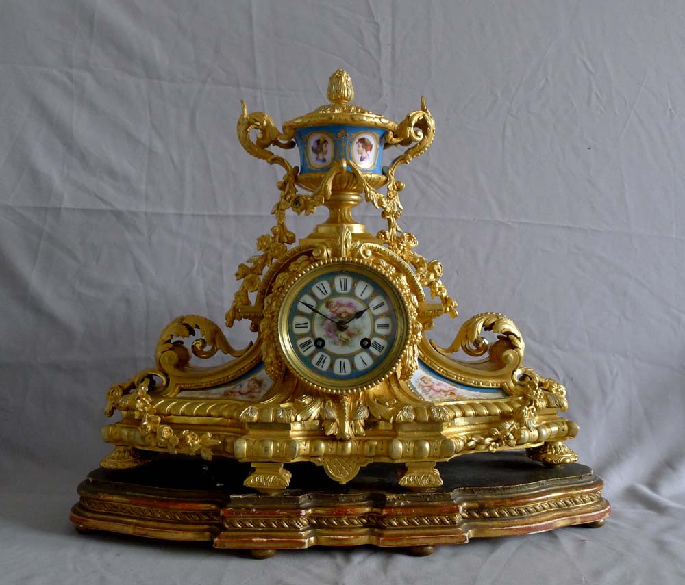 Antique French porcelain and ormolu mantel clock with silver highlights mantel clock.