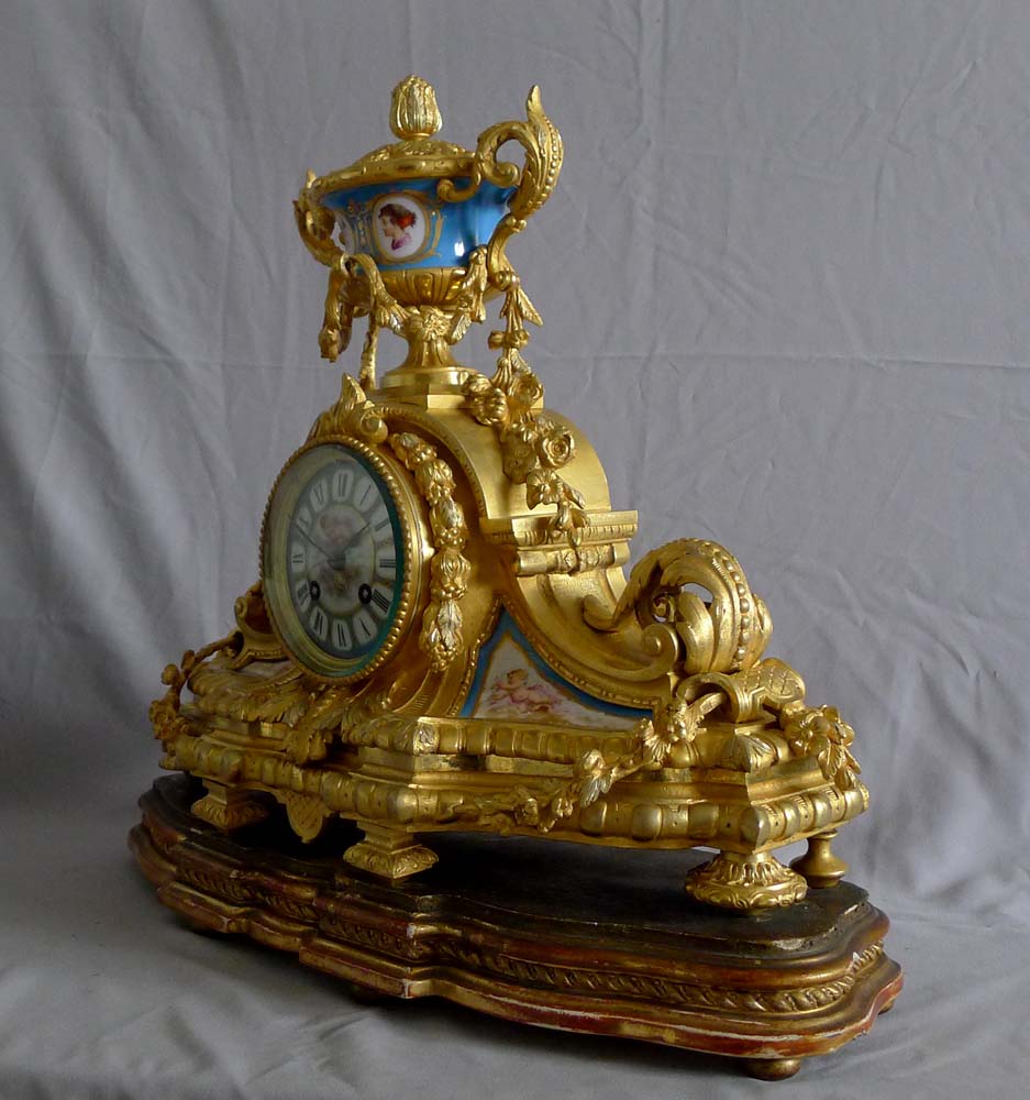 Antique French porcelain and ormolu mantel clock with silver highlights mantel clock.