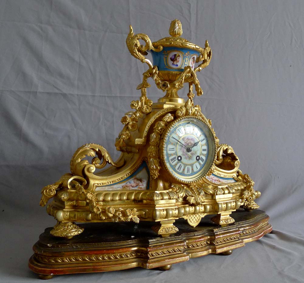Antique French porcelain and ormolu mantel clock with silver highlights mantel clock.