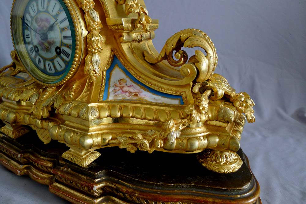 Antique French porcelain and ormolu mantel clock with silver highlights mantel clock.