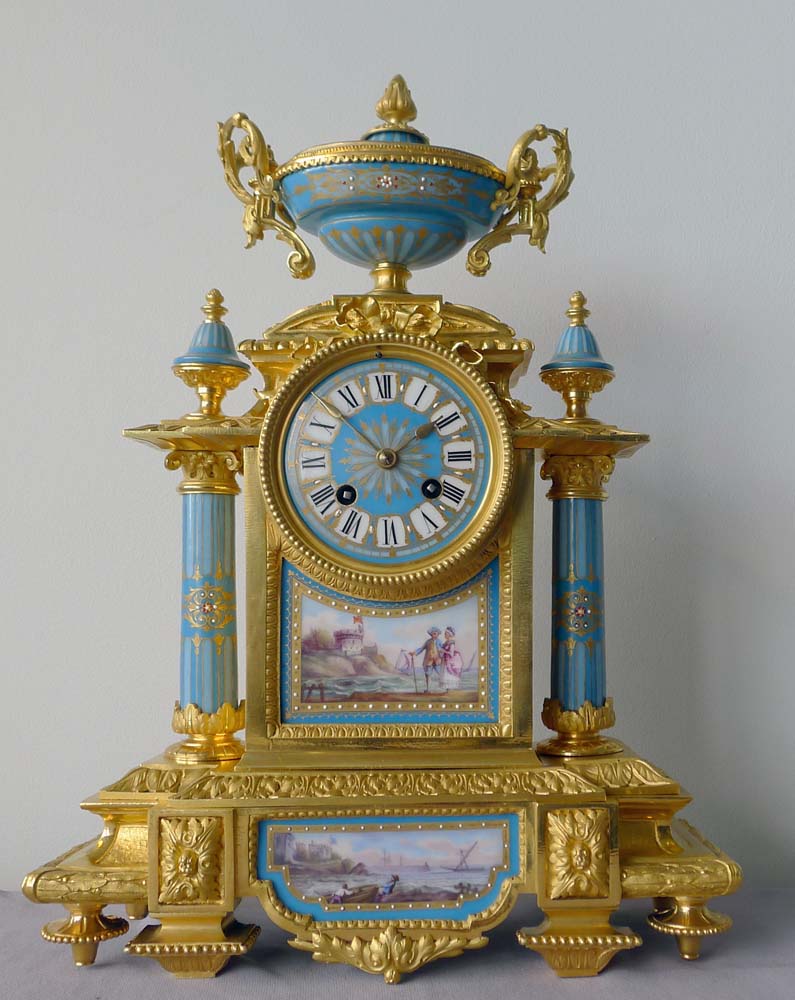 Antique French porcelain and ormolu mantel clock with Sevres style plaques.