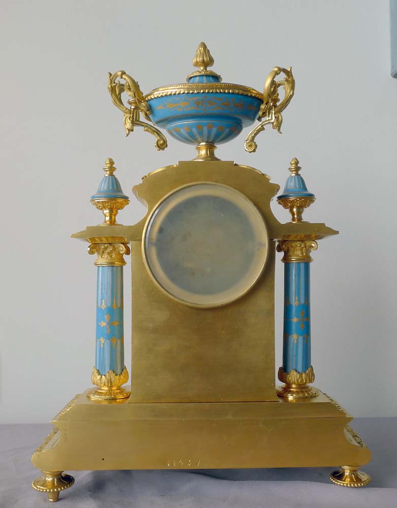 Antique French porcelain and ormolu mantel clock with Sevres style plaques.