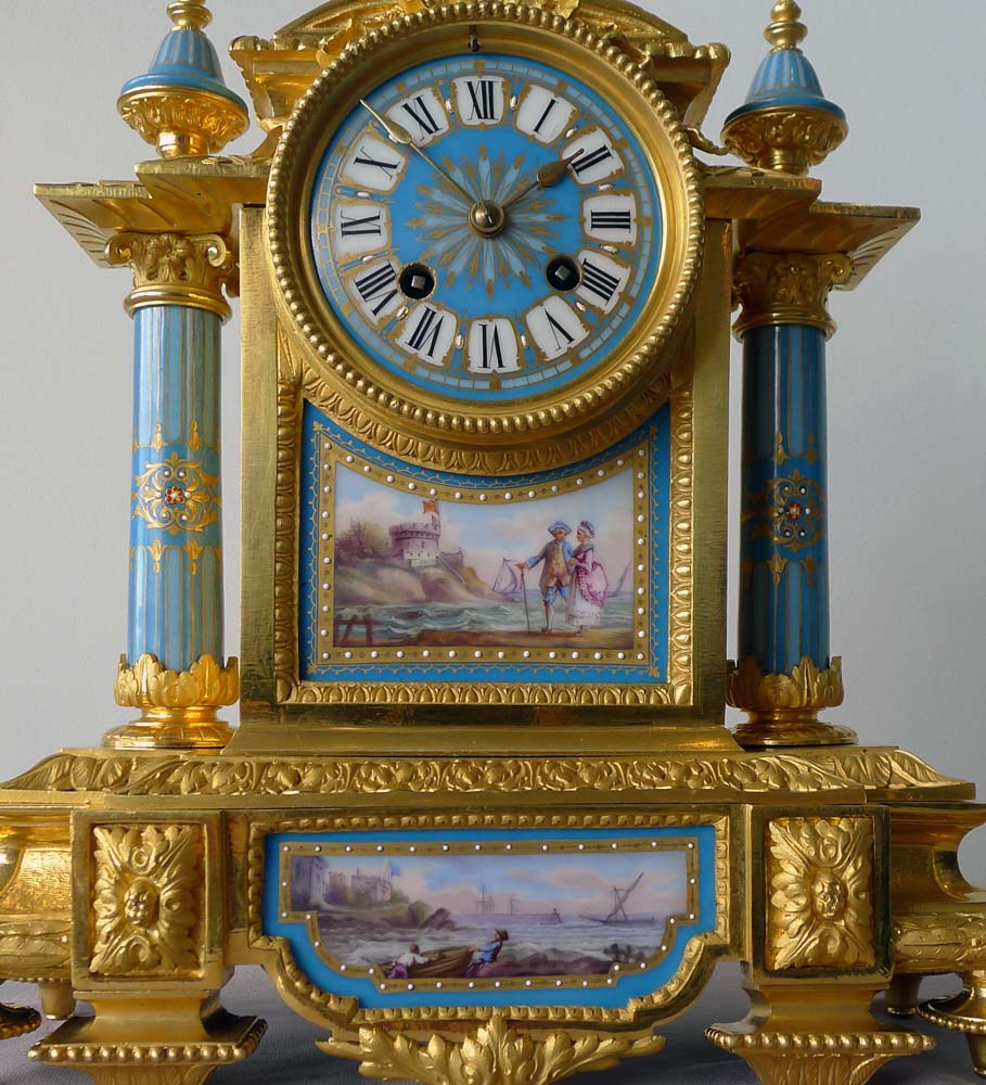 Antique French porcelain and ormolu mantel clock with Sevres style plaques.