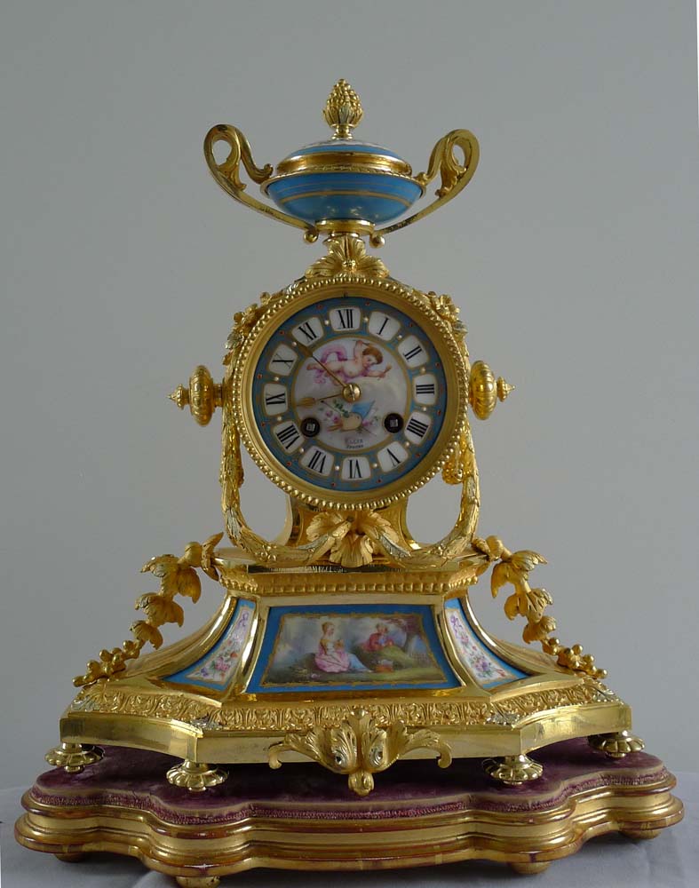Antique French Napoleon III porcelain and ormolu mantel clock under glass dome.