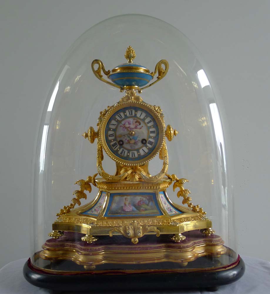 Antique French Napoleon III porcelain and ormolu mantel clock under glass dome.