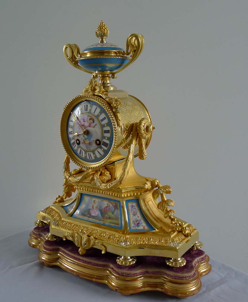 Antique French Napoleon III porcelain and ormolu mantel clock under glass dome.