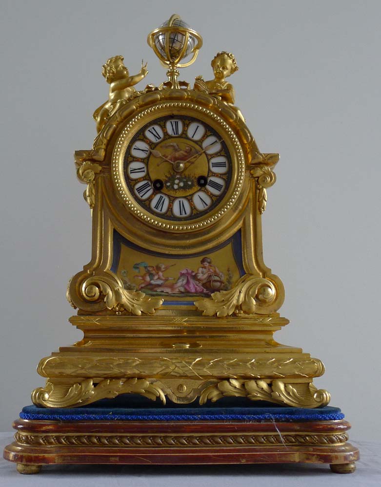 Fine antique French porcelain and ormolu mantel clock with two figures beside a globe.