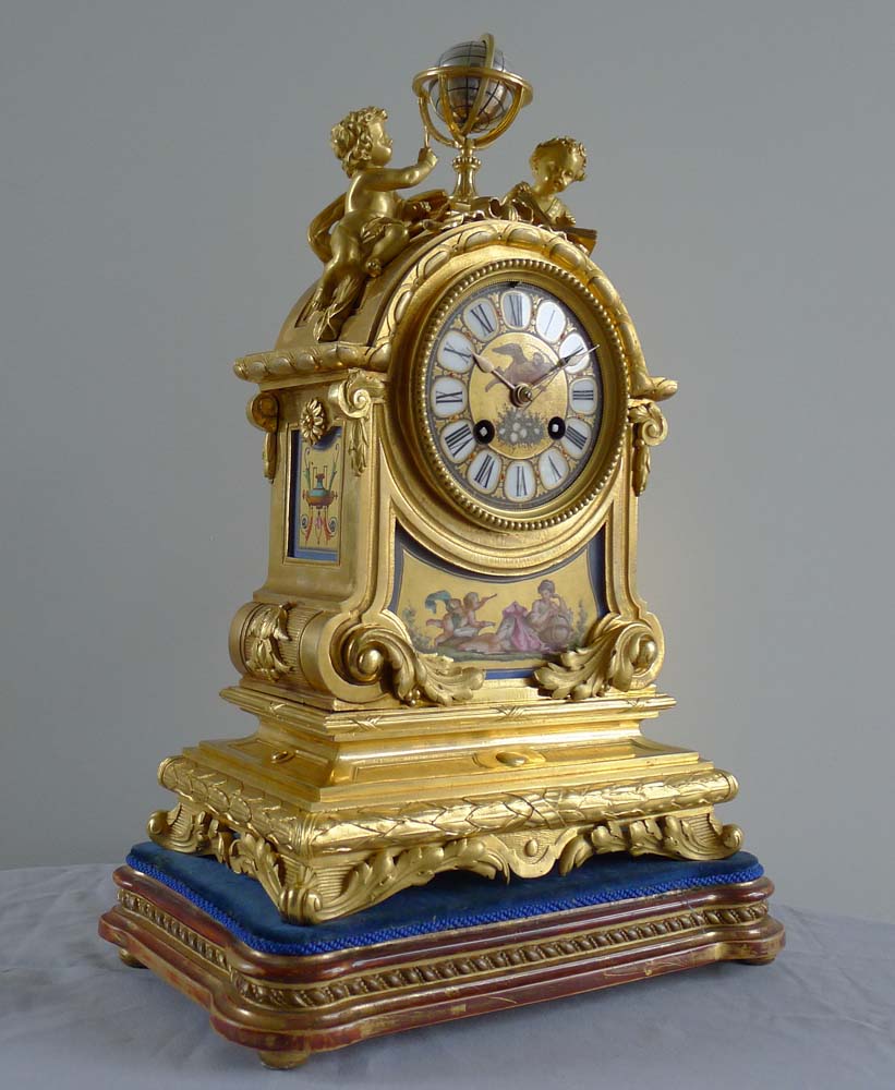 Fine antique French porcelain and ormolu mantel clock with two figures beside a globe.
