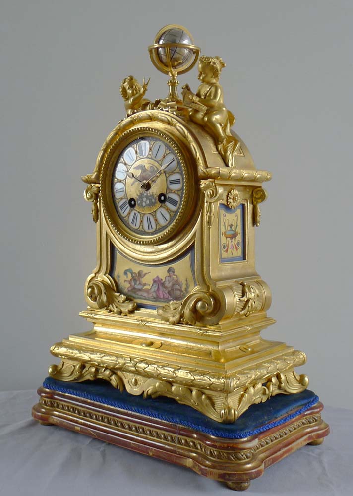 Fine antique French porcelain and ormolu mantel clock with two figures beside a globe.