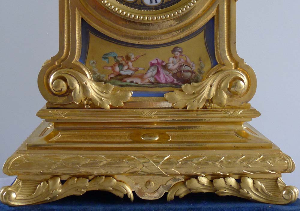 Fine antique French porcelain and ormolu mantel clock with two figures beside a globe.